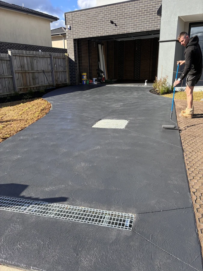 Driveway after a dark concrete sealing coat was applied