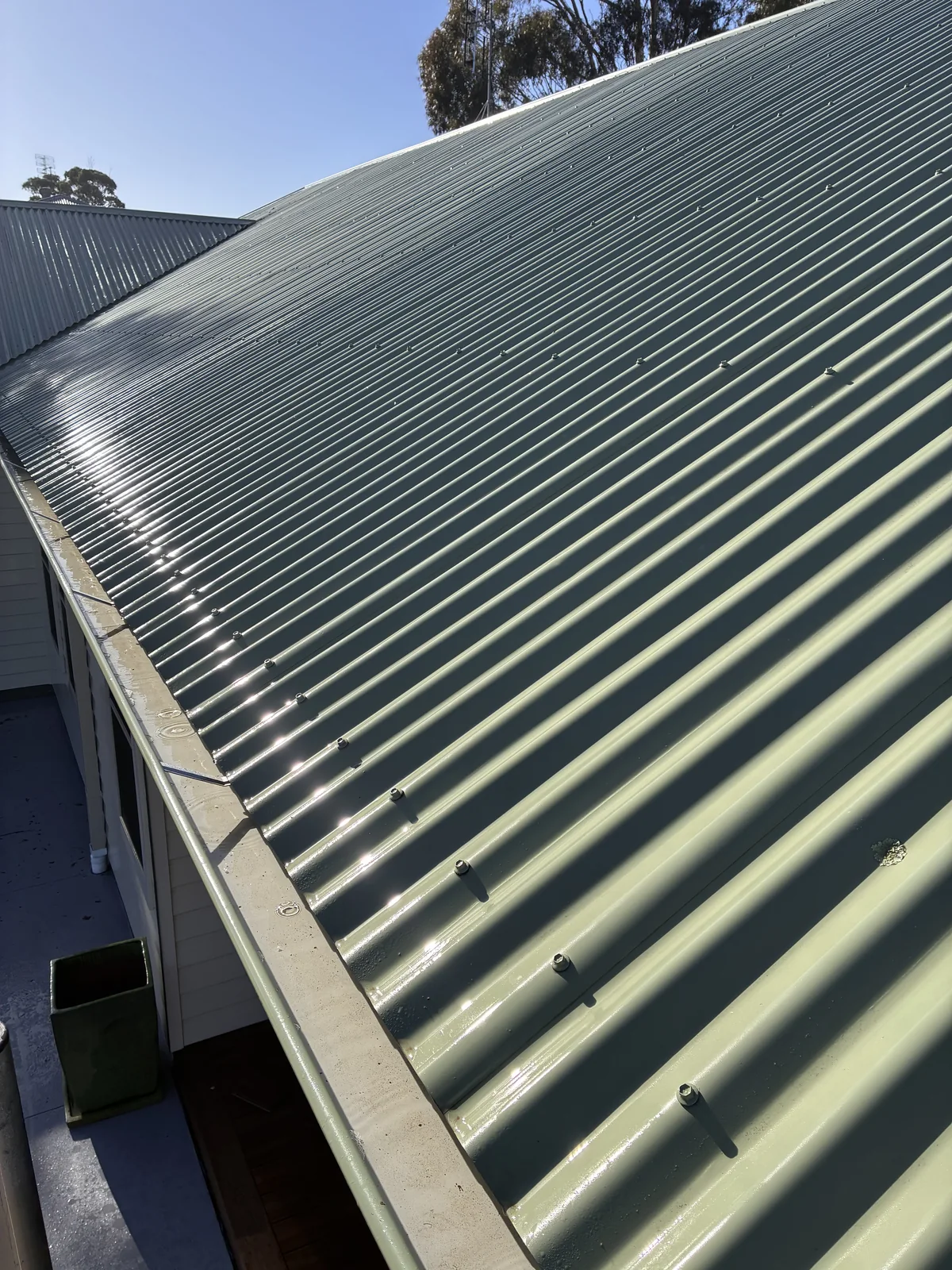 Clean metal roof and gutter edge photographed after exterior cleaning